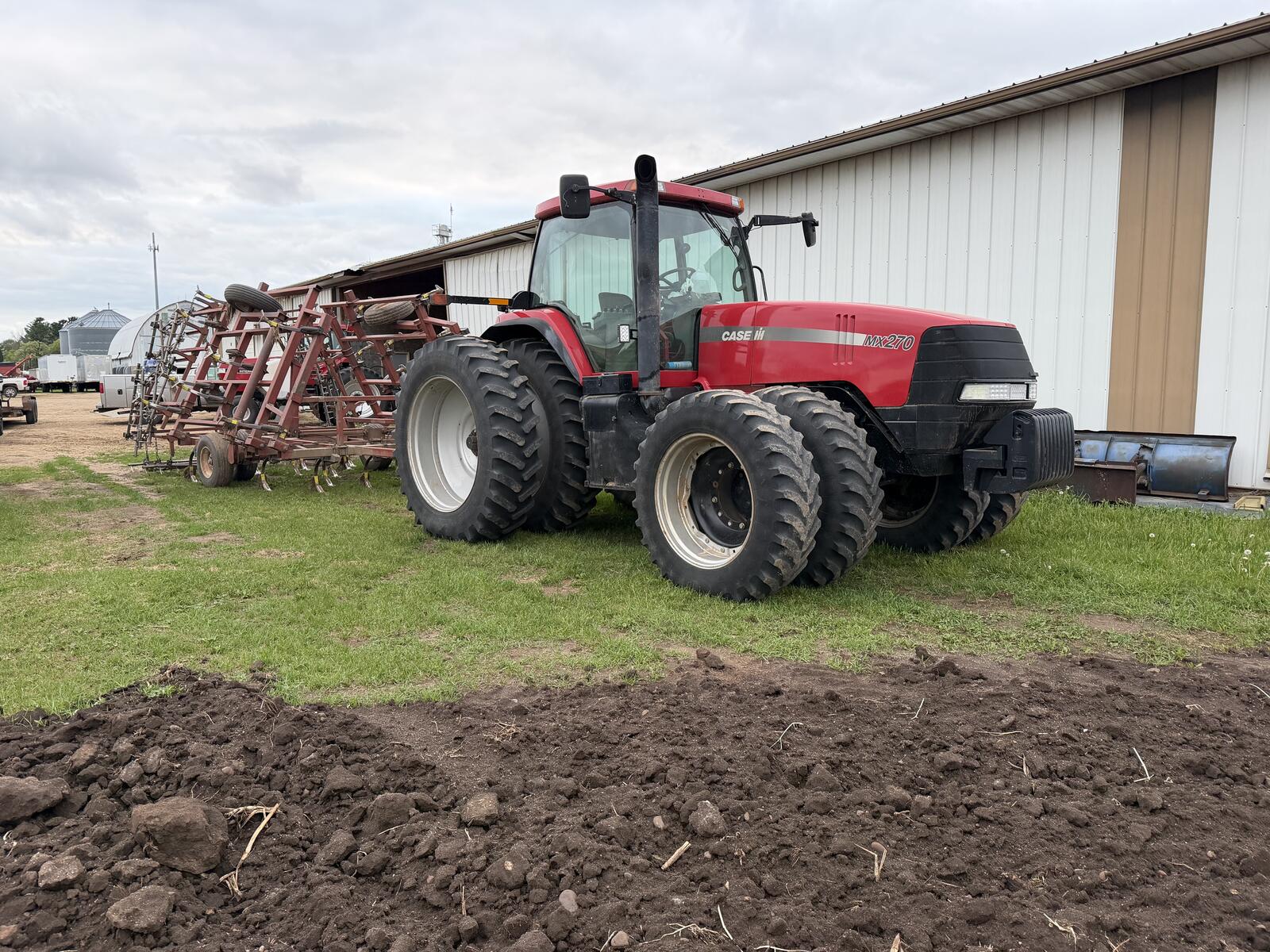 Case IH MX270 after refinishing — clean Case red finish with disc