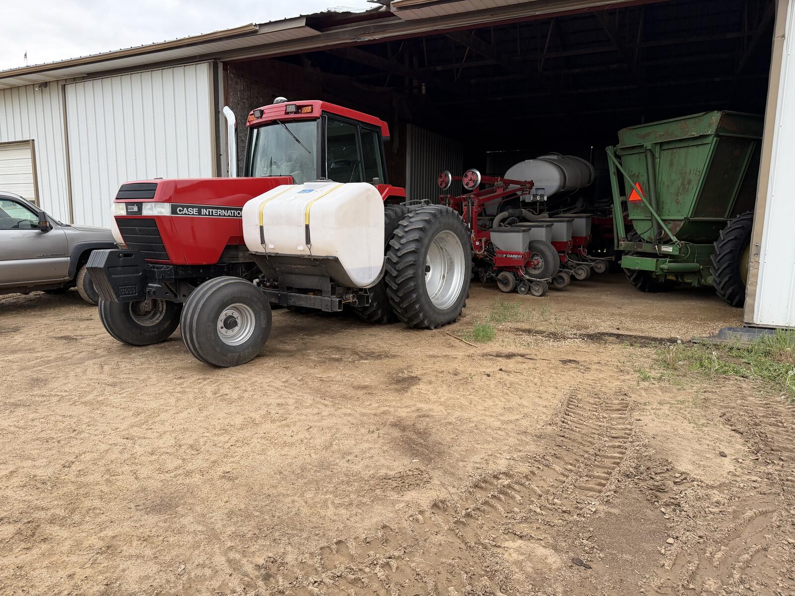 Case IH MX270 after refinishing — finished Magnum with tank at the shed