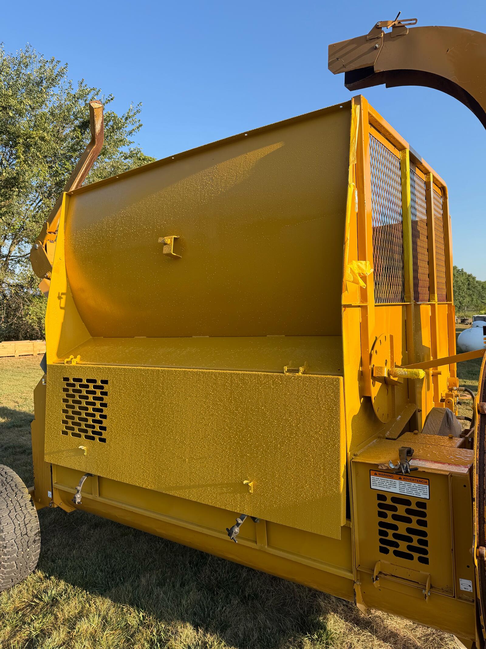 Haybuster 2574 after refinishing — clean gloss yellow finish