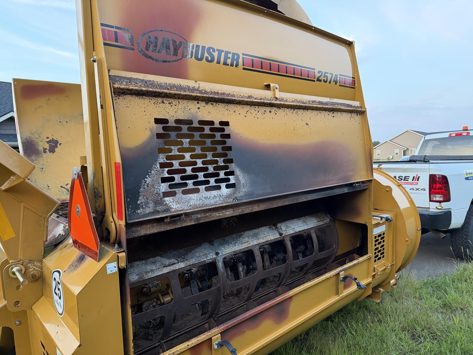 Haybuster 2574 before refinishing — scorched, rusted yellow finish