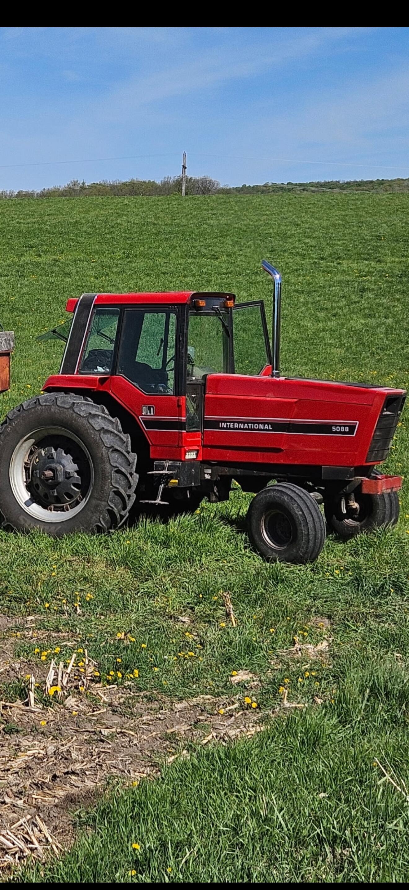 International 5088 after refinishing — glossy red finish in the field